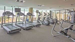 A gym with treadmills, elliptical machines, and weight equipment.