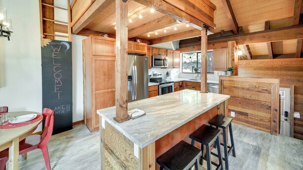 A modern kitchen with wooden beams, a marble island, and stainless steel appliances. - 1 Mi to Northstar Skiing/snowboarding: Cozy Condo (Truckee)