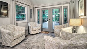 A cozy living room with two patterned armchairs, a round rug, and a lamp. - Walk to Main St: Highlands Cottage w/ Fireplace (Highlands)