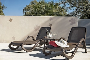 Two lounge chairs with a table between them, a glass of white wine, and a red towel on the table. - APP4 Romantic villa with pool - 5 min from the beach! (Novigrad)
