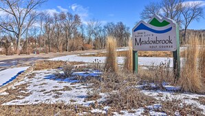 A sign for Meadowbrook Golf Course in Rapid City, surrounded by snow and leafless trees. - Rapid City Home w/ Patio by Canyon Lake Park! (Rapid City)