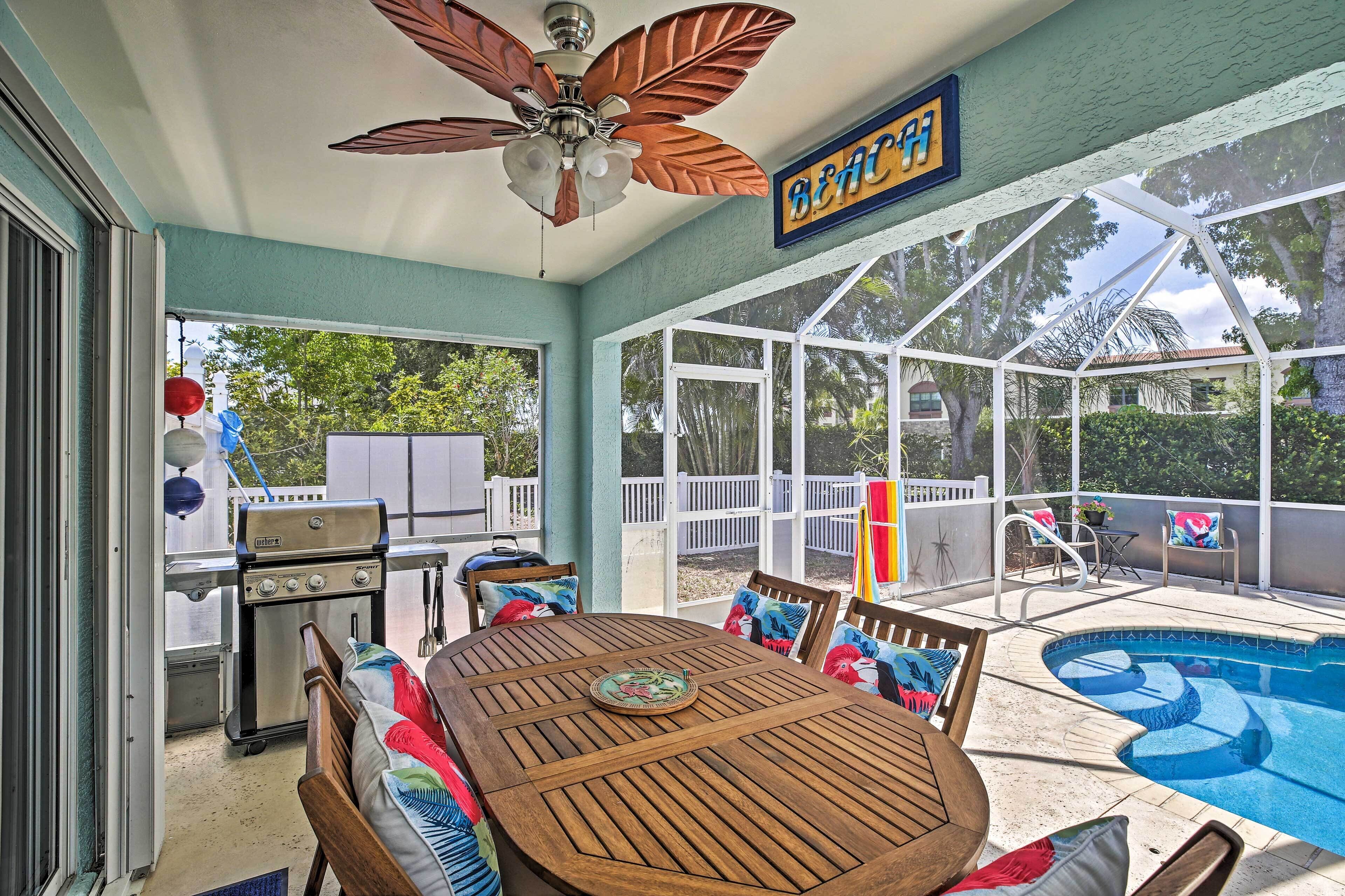 A covered patio with a pool, a grill, and a ceiling fan.