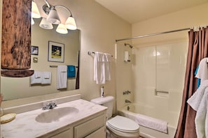 A bathroom with a sink, toilet, and shower. There are towels hanging on the wall and a mirror above the sink. - Angel Fire Mtn Escape: Walk to Chile Express Lift! (Angel Fire)