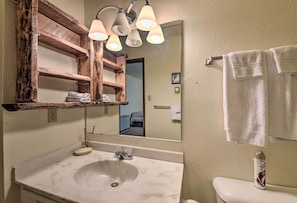 A bathroom with a white sink, wooden shelves, a mirror, and a toilet. - Angel Fire Mtn Escape: Walk to Chile Express Lift! (Angel Fire)