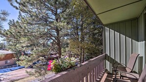 A balcony with a wooden railing, a chair, and a row of potted plants. - Angel Fire Mtn Escape: Walk to Chile Express Lift! (Angel Fire)