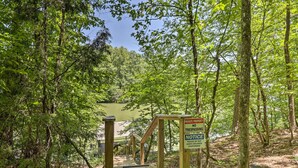 A wooden staircase leading into a forested area with a sign indicating private property and no trespassing. - Ouachita River Cabin: Royal Haven w/ Dock! (Royal)