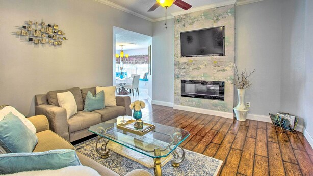 A living room with a sofa, coffee table, and fireplace. - Family-friendly Rowlett Home ~ 23 Mi to Dallas (Rowlett)