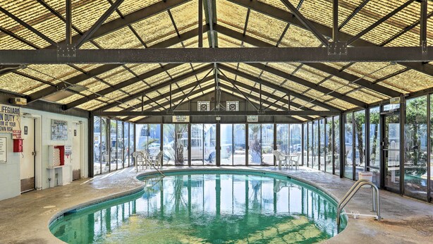 An indoor swimming pool with a covered roof, clear glass walls, and a lifeguard station. - 4 Mi to Cherry Grove Beach: Studio w/ Pool Access (Little River)