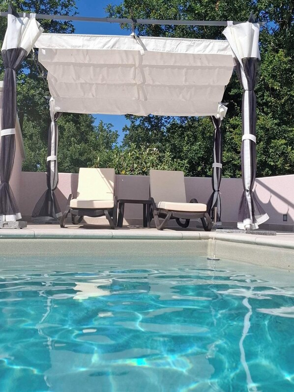 A poolside area with a covered seating area and lounge chairs. - APP1 Romantic Villa with Pool - 5 Min. from the Beach! (Novigrad)