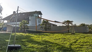 A house with a sloped roof, a fenced yard, and a hammock. - APP1 Romantic villa with pool - 5 min from the beach! (Novigrad)