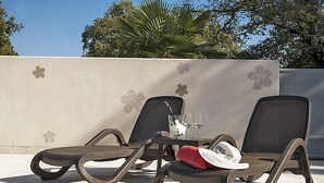 Two lounge chairs with a table between them, a glass of white wine, and a red towel on the table. - APP1 Romantic villa with pool - 5 min from the beach! (Novigrad)