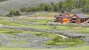 A large, two-story lodge with a prominent balcony, situated on a golf course with well-maintained fairways and greens. - Ski, Soak & Explore! Granby Getaway w/ Mtn Views (Granby)