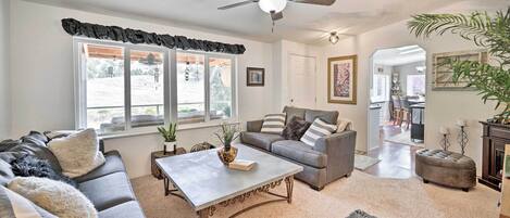 A living room with a sofa, a coffee table, and a fireplace.