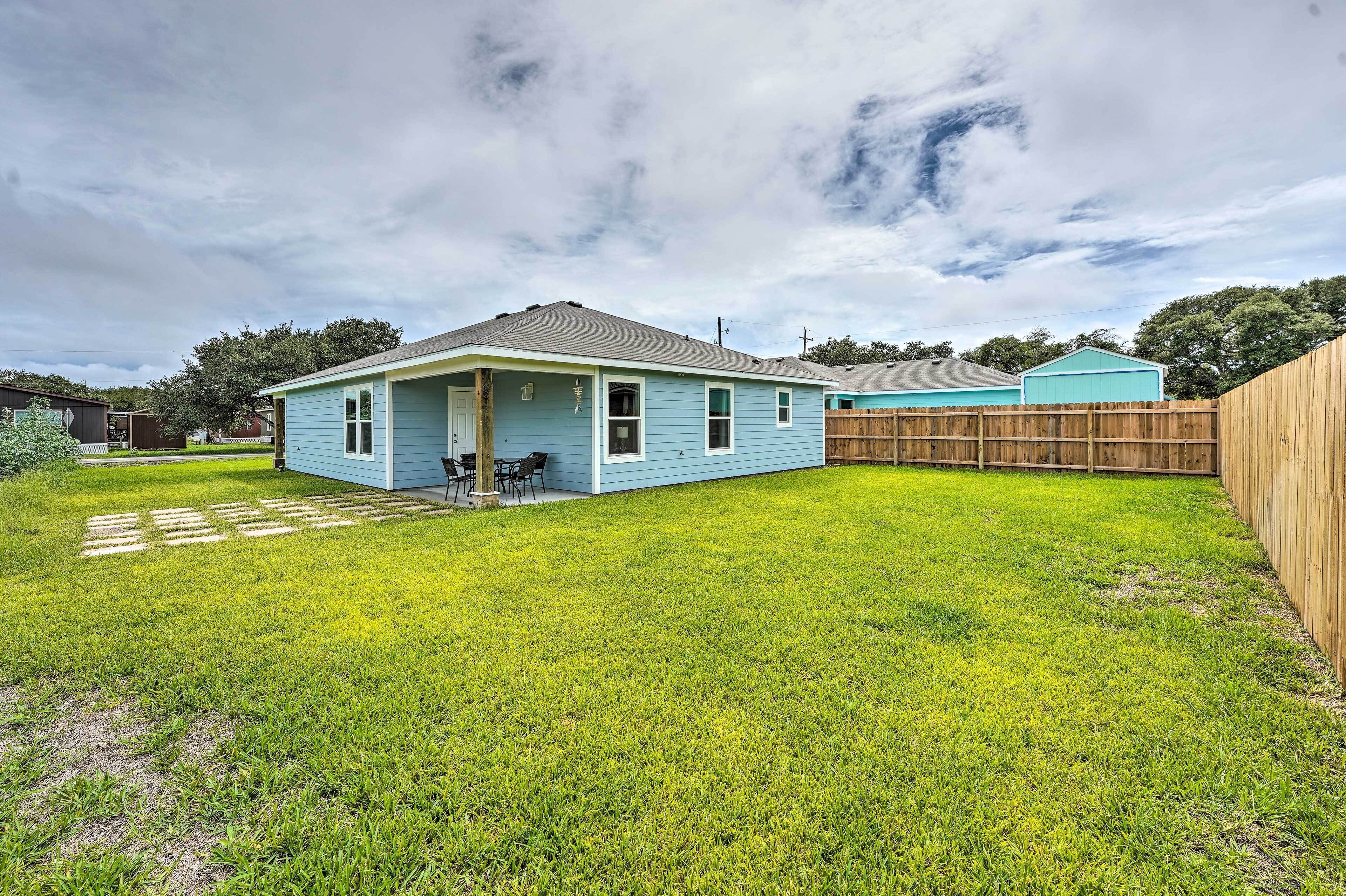 A single-story house with a front porch and a small backyard.