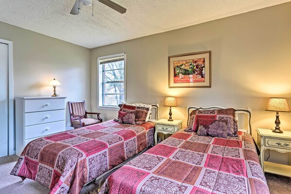 A bedroom with two beds, a dresser, a chair, and a window. - Park Once, Walk to Every Ole Miss Tradition (Oxford)