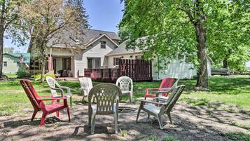 A house with a backyard patio area featuring outdoor furniture.