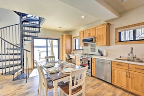 A modern kitchen with wooden cabinets, a stainless steel refrigerator, and a built-in oven. - Happys Haven Cabin w/ Gas Grill & Fire Pit! (Lodi)