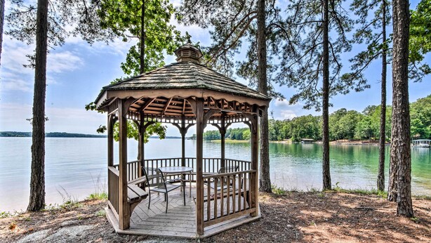 A gazebo with a wooden roof and open sides, surrounded by trees and overlooking a body of water. - Views, Pools & Marina: Lake Keowee Condo! (Salem)