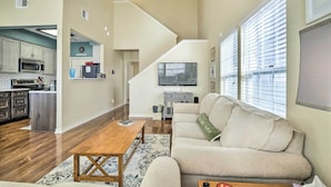 A spacious living area with a sofa, coffee table, and a view of the kitchen. - Walk to Lake: Family Gem w/ Pool Access in Afton (Afton)