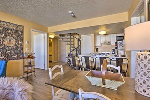 Enjoy meals in a classic dining area with a wooden table and comfortable chairs.