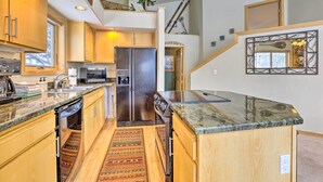 A modern kitchen with wooden cabinets, stainless steel appliances, and a granite countertop. - Frisco Townhome w/ Hot Tub - 10 Mi to Breckenridge (Frisco)