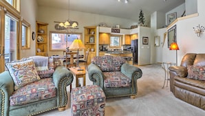 A cozy living room with a fireplace, a dining area, and a kitchen. - Frisco Townhome w/ Hot Tub - 10 Mi to Breckenridge (Frisco)