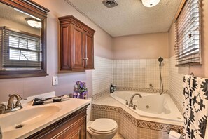 A bathroom with a double sink, a toilet, a bathtub, and a shower. - Cozy Cody House <10 Mi to Buffalo Bill Center! (Cody)