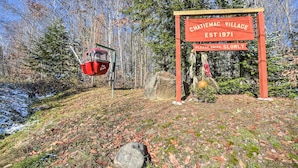 Schild für Chatiemac Village mit der Aufschrift 'Bitte langsam fahren'.
