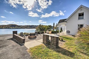 A house with a patio overlooking a lake, stone seating, and a fire pit. - 1872 Bethlehem Home w/ View of Ohio River! (Otto)