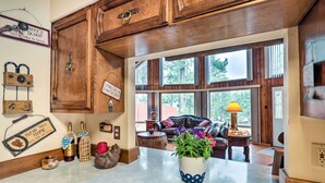 A kitchen with wooden cabinets, a marble countertop, and a potted plant. - A-frame Ruidoso Retreat w/ Deck, Grill & Views! (Ruidoso)