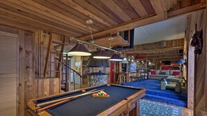 A pool table in a wooden room with a bar area and seating. - Sugar Mountain Resort Condo w/ Pool Table & Views! (Banner Elk)