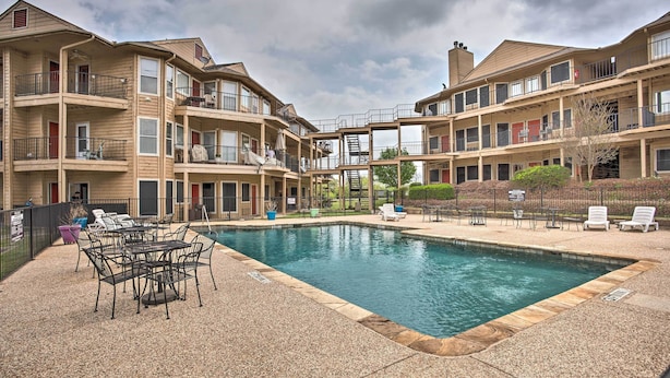 A multi-story building with a swimming pool, outdoor seating, and a covered walkway. - Resort Condo in Pottsboro w/ Lake Texoma Access! (Pottsboro)