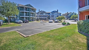 A multi-story residential building with a parking lot in front. - Resort Condo in Pottsboro w/ Lake Texoma Access! (Pottsboro)