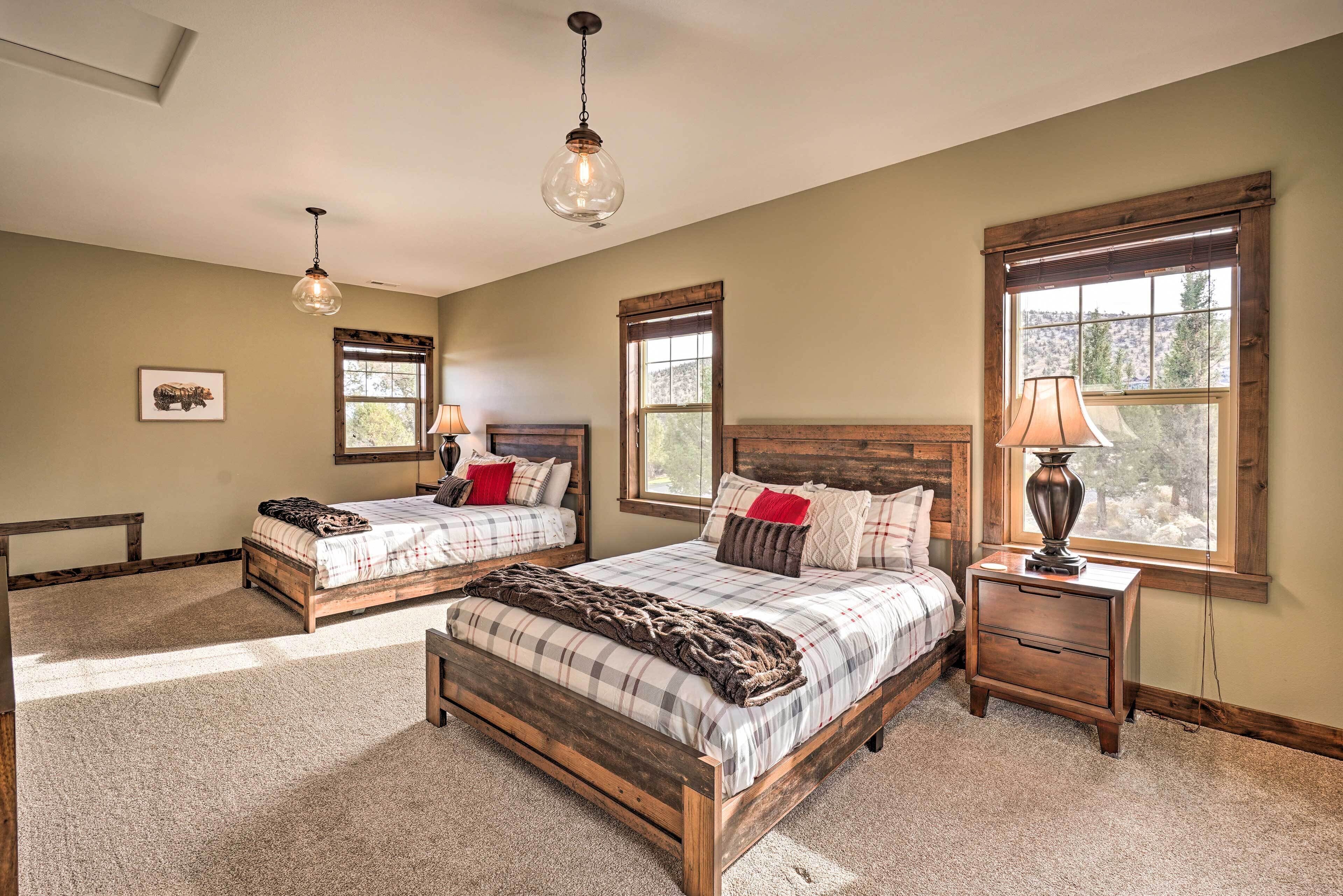 A bedroom with two beds, a wooden headboard, a nightstand, and a lamp.