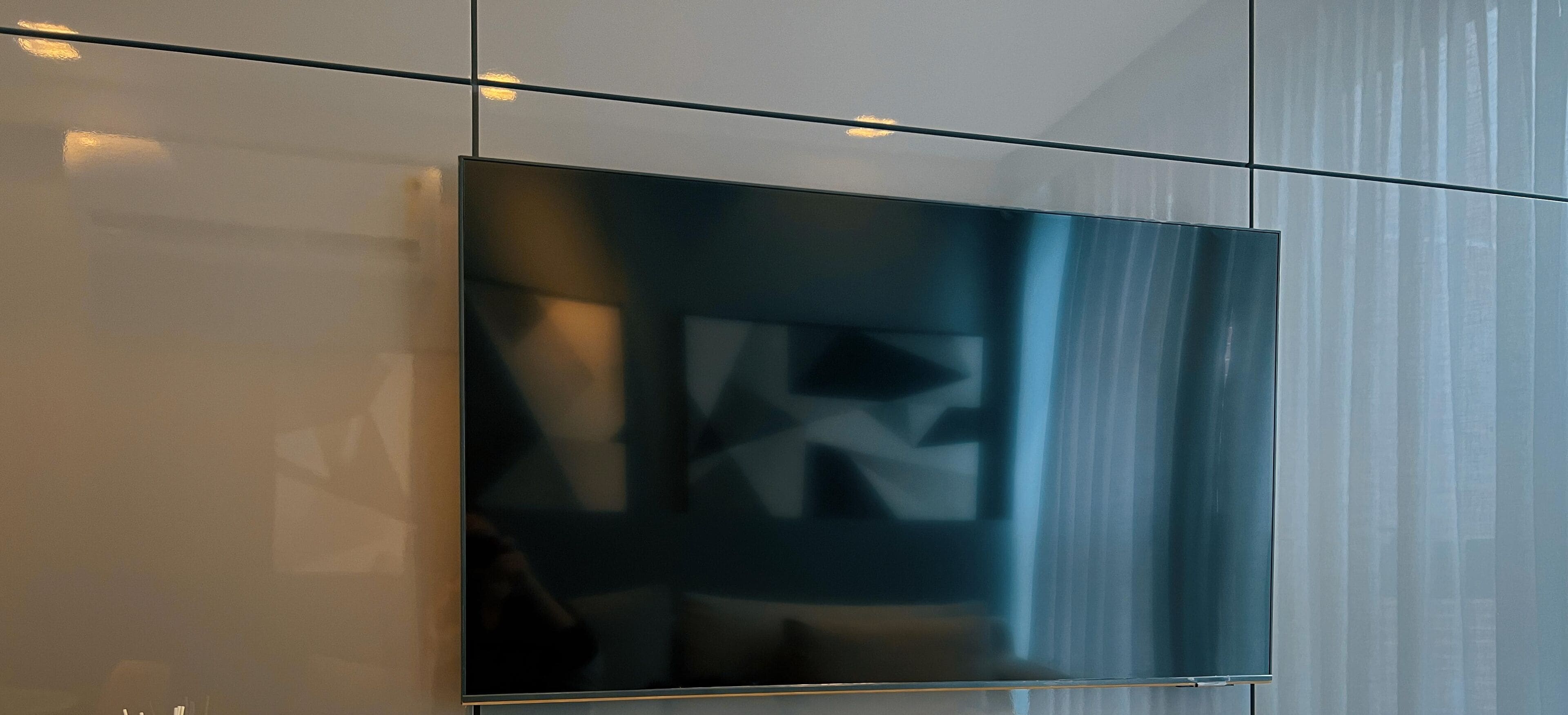A modern interior with a large flat-screen TV mounted on a wall.