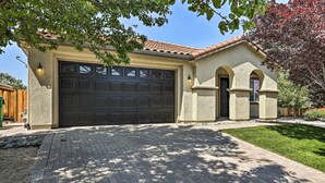 A house with a large garage, a brick driveway, and a well-maintained lawn. - 12 Mi to Riverwalk District: Quiet Reno Retreat (Reno)