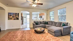 A spacious living room with a sectional sofa, a round coffee table, and a ceiling fan. - 12 Mi to Riverwalk District: Quiet Reno Retreat (Reno)