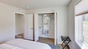 A bedroom with a bed, a closet, and a window. - Creek Access + Fire Pit! Red Lodge Family Retreat (Red Lodge)