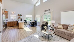 A spacious living area with a kitchen, dining table, and seating area. - Creek Access + Fire Pit! Red Lodge Family Retreat (Red Lodge)