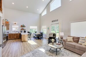 A spacious living area with a kitchen, dining table, and seating area. - Creek Access + Fire Pit! Red Lodge Family Retreat (Red Lodge)