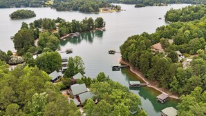 A lakeside property with multiple docks, boats, and houses surrounded by dense trees. - Lakefront Keowee Home w/ Dock, 14 Mi to Clemson (Seneca)