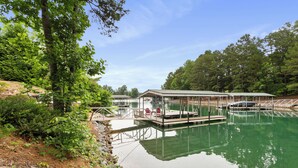 A tranquil lakeside setting with a dock, covered seating area, and a small pavilion. - Lakefront Keowee Home w/ Dock, 14 Mi to Clemson (Seneca)