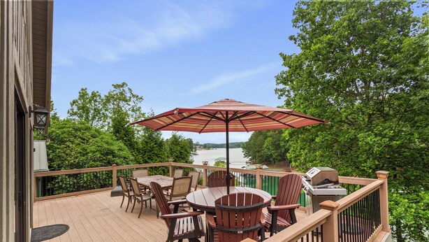 A wooden deck with a table and chairs, a grill, and a view of a lake. - Lakefront Keowee Home w/ Dock, 14 Mi to Clemson (Seneca)