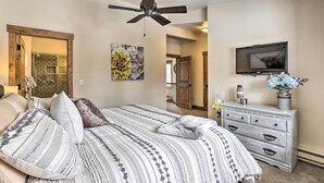 A bedroom with a bed, a ceiling fan, a dresser, and a TV on the wall. - Frisco Home w/ Mountain Views: Walk to Main St! (Frisco)
