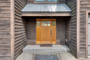A wooden building with a central door, a metal roof, and a gravel pathway. - Home w/ Fire Pit, 7 Mi to Attitash Mtn Resort (Jackson)