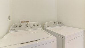 A laundry area with two Whirlpool front-loading washers. - Seabrook Getaway w/ Balconies & Bay Views! (Seabrook)