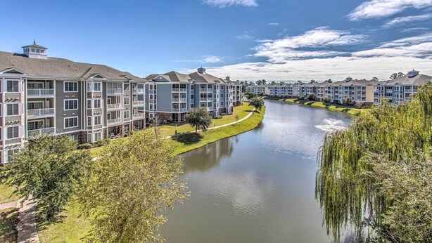 A residential building complex with multiple balconies and a canal running through the middle. - 3 Mi to Beach & Golf: Resort Condo in Myrtle Beach (Myrtle Beach)