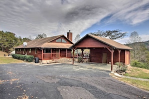 A two-story wooden cabin with a covered porch, a satellite dish, and a chimney. - Luxe Cabin w/ Covered Pool + Smoky Mountain Vistas (Sevierville)