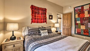 A bedroom with a bed, two bedside tables, a wall hanging, and a quilt. - 1 Mi to Santa Fe Plaza: Quiet Home w/ Patio (Santa Fe)