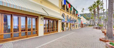A street with storefronts, including a hotel named 'Avalon Grille' and a 'Hotel Mar'.